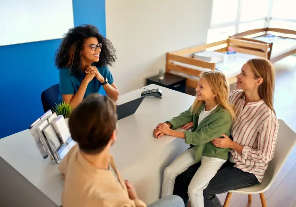 Happy woman consulting with family at Eastex customer service desk.