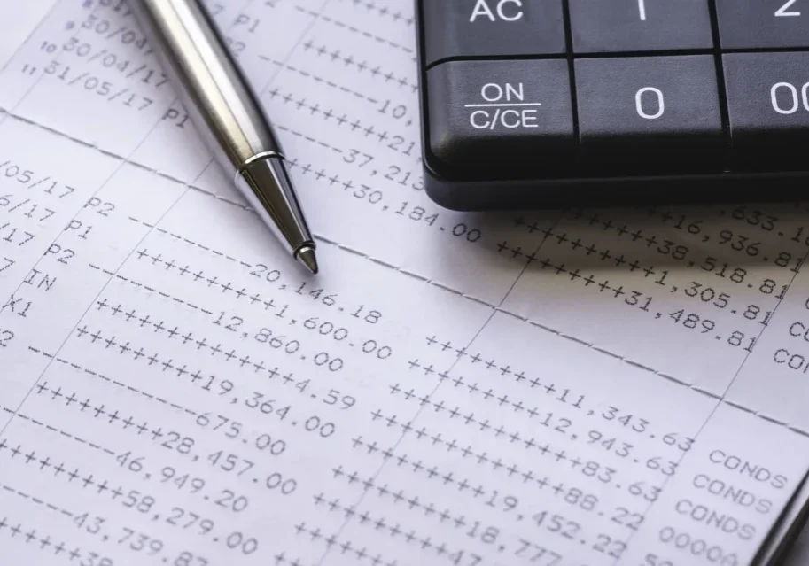 Close-up of financial data with calculator and pen for eStatements.