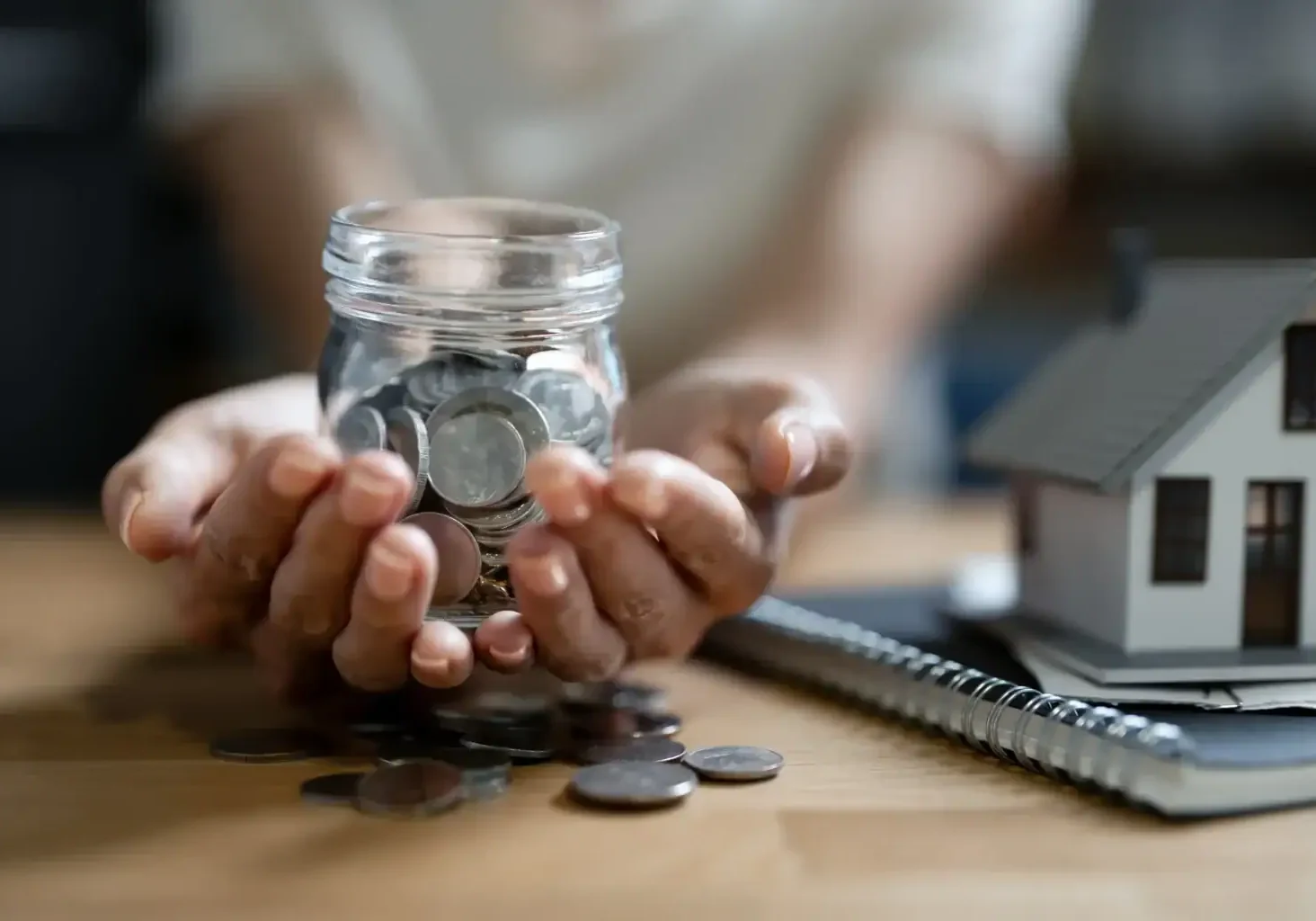 closeup-hands-holding-glass-pot-of-coins-bank-fi-2026-03-16-00-36-25-utc