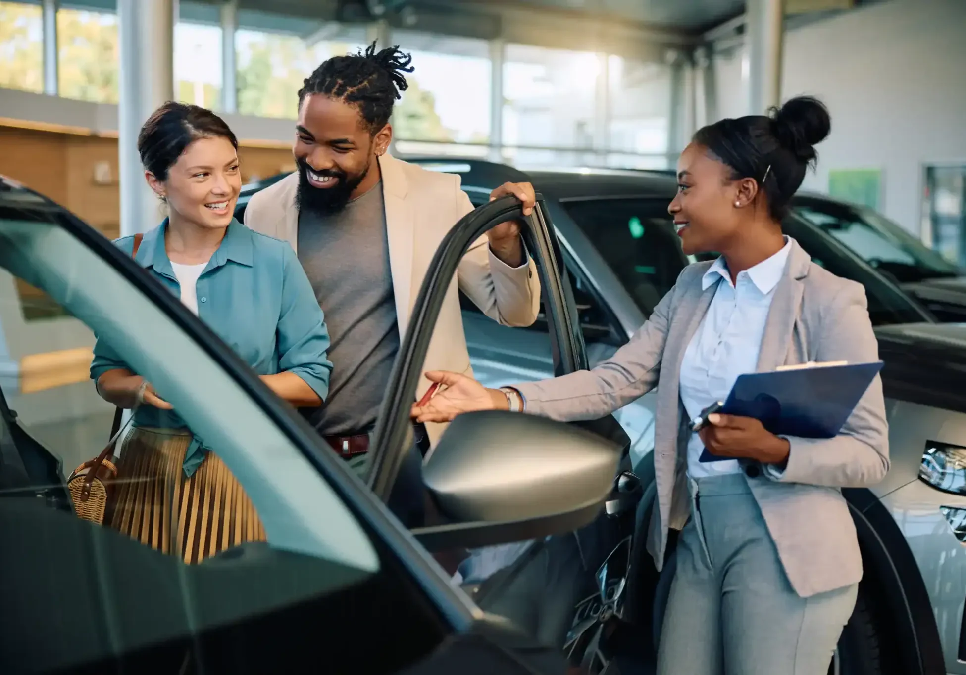 couple-visiting-car-dealership-with-sales-represen-2026-03-16-03-30-17-utc