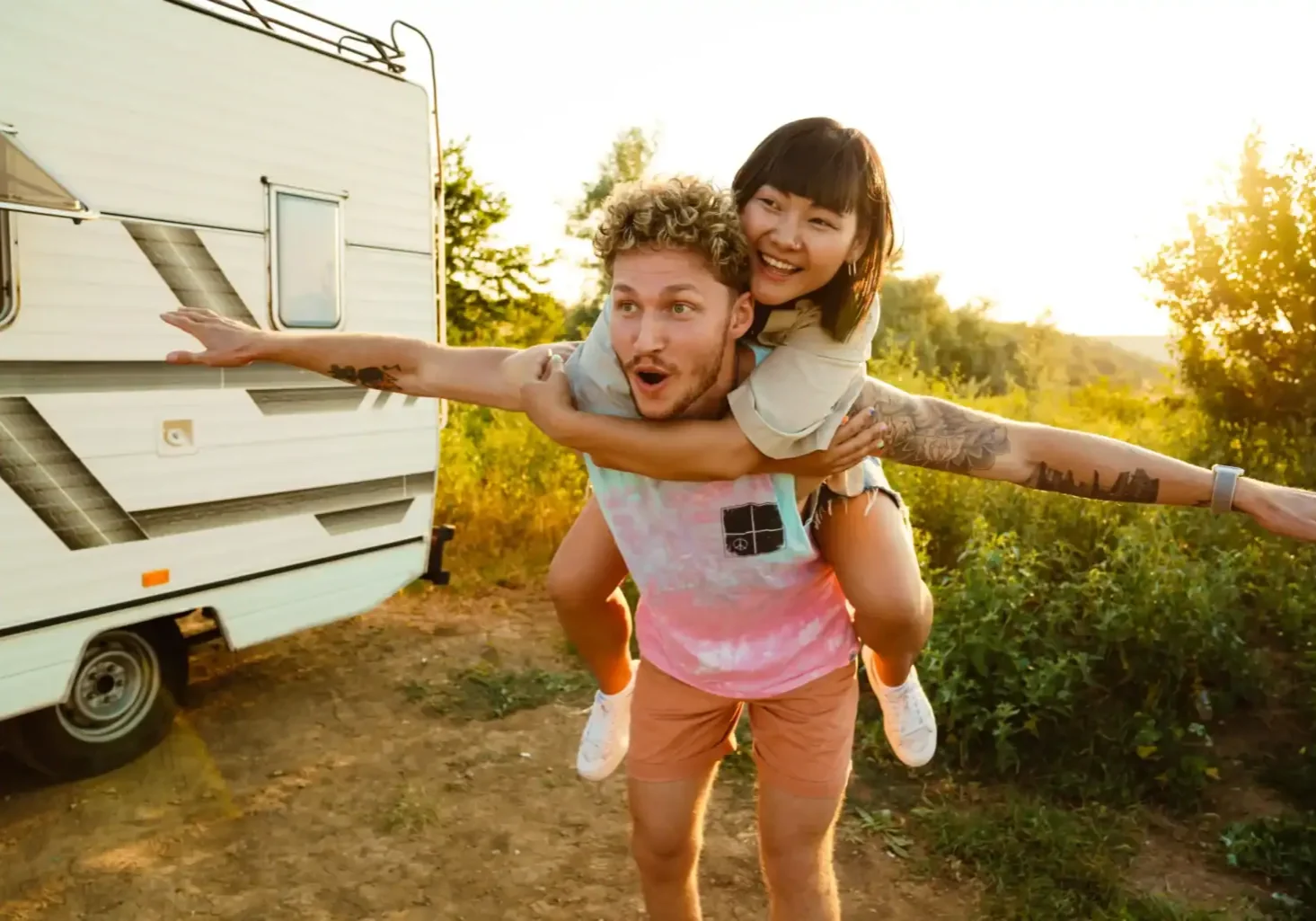 happy-couple-fun-piggyback-ride-by-camper-2026-03-19-04-23-44-utc