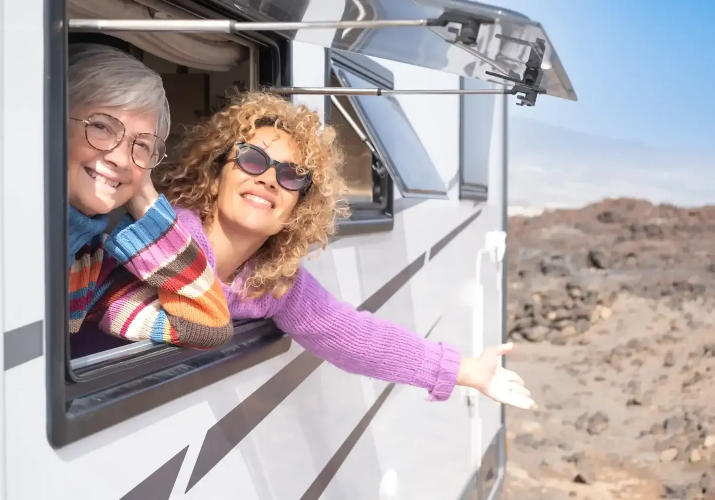 smiling-women-enjoying-road-trip-in-camper-van-2026-01-05-23-28-41-utc