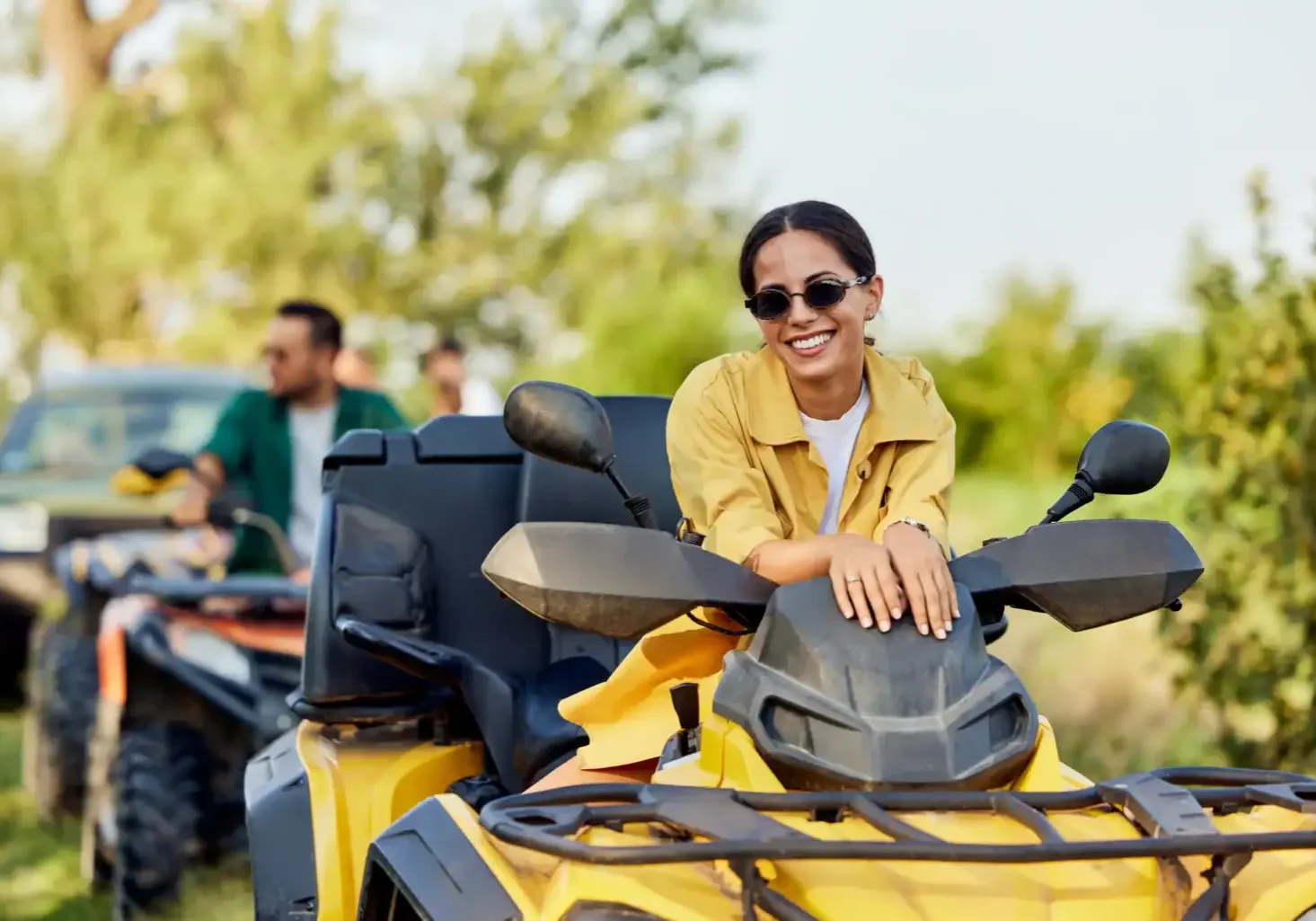 woman-smiling-on-atv-with-friends-in-background-2026-04-01-17-32-30-utc